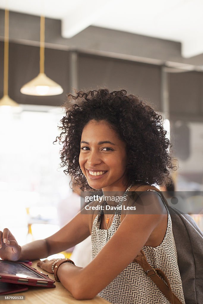 Businesswoman using digital tablet in cafe