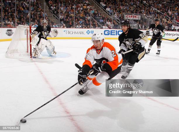Matt Read of the Philadelphia Flyers tries to change direction in front of Kris Letang of the Pittsburgh Penguins during the first period on November...