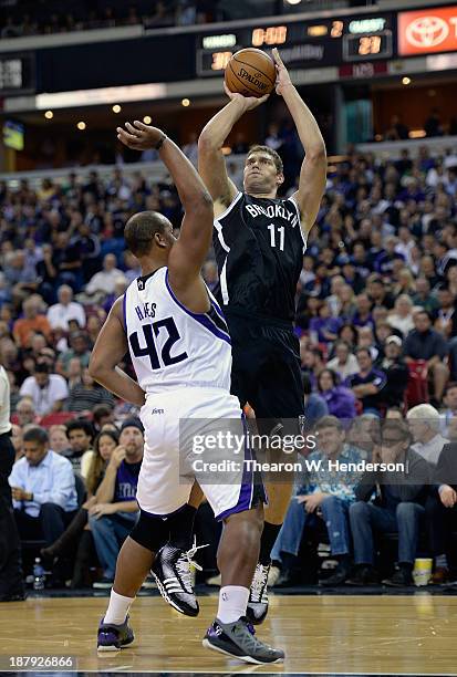 Brook Lopez of the Brooklyn Nets shoots over Chuck Hayes of the Sacramento Kings at Sleep Train Arena on November 13, 2013 in Sacramento, California....