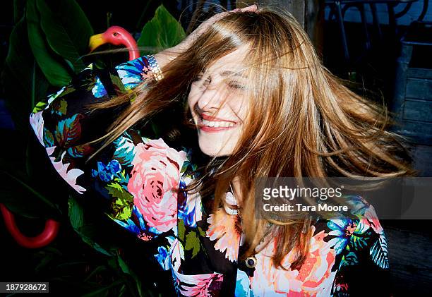 woman smiling with windswept hair - capelli lunghi foto e immagini stock