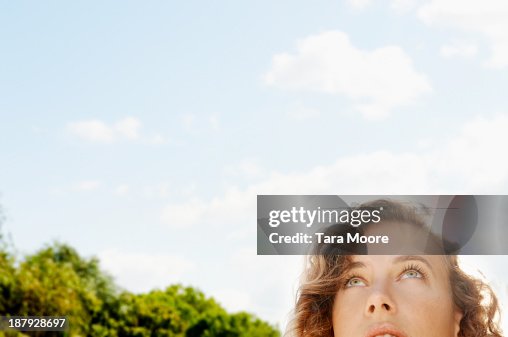 Woman's face looking up to sky Woman's face looking up to sky