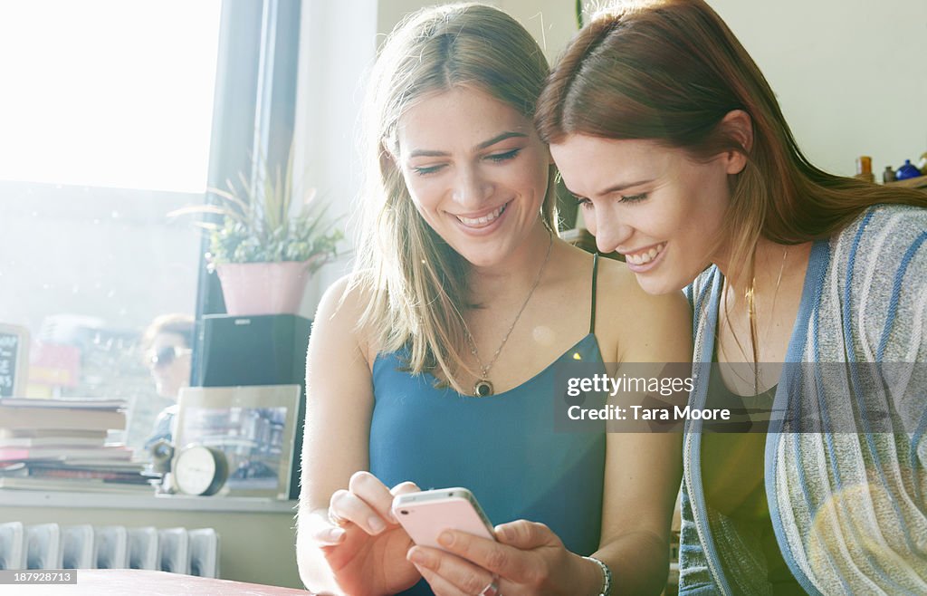 Two woman looking at mobile phone