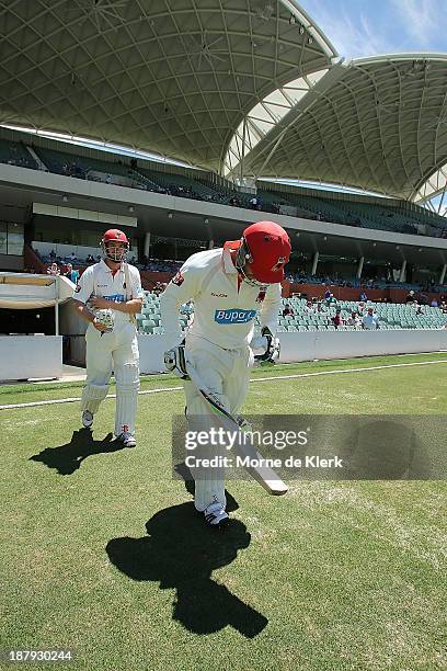 Michael Klinger and Phillip Hughes of the Redbacks take to the field during day two of the Sheffield Shield match between the Redbacks and the...