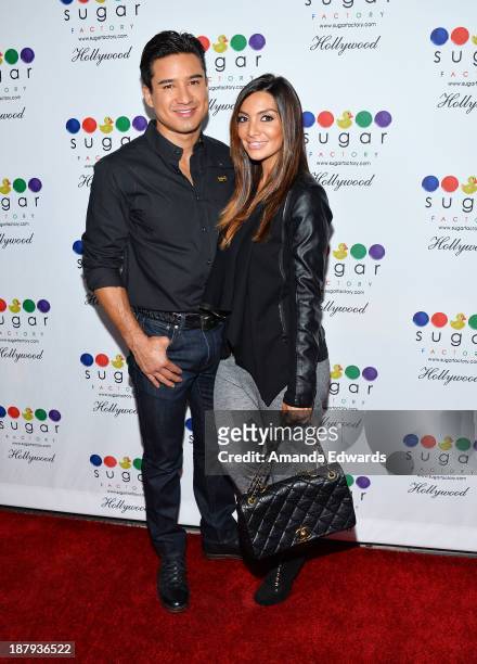 Actor Mario Lopez and his wife Courtney Mazza arrive at the grand opening of Sugar Factory Hollywood at Sugar Factory on November 13, 2013 in...