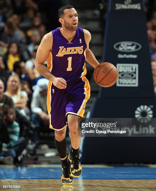 Jordan Farmar of the Los Angeles Lakers controls the ball against the Denver Nuggets at Pepsi Center on November 13, 2013 in Denver, Colorado. The...