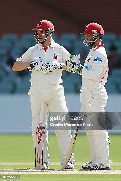 Michael Klinger and Phillip Hughes of the Redbacks looks on during day two of the Sheffield Shield match between the Redbacks and the Warriors at...