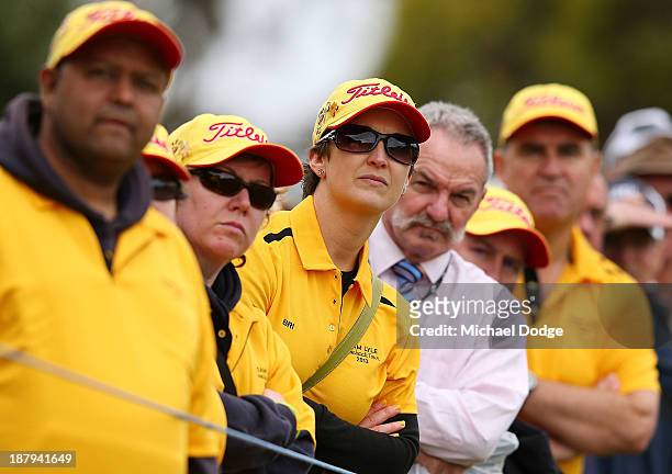 Briony Lyle watches a ball hit by husband Jarrod Lyle of Australia during round one of the 2013 Australian Masters at Royal Melbourne Golf Course on...