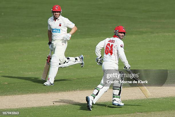 Michael Klinger and Phillip Hughes of the Redbacks run between the wickets during day two of the Sheffield Shield match between the Redbacks and the...