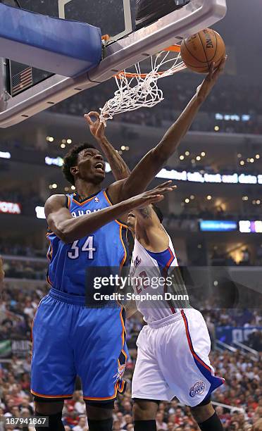 Hasheem Thabeet of the Oklahoma City Thunder shoots over Matt Barnes of the Los Angeles Clippers at Staples Center on November 13, 2013 in Los...