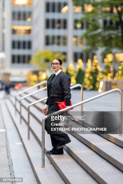 beautiful female business person seen on the street of new york - manhattan center stock pictures, royalty-free photos & images