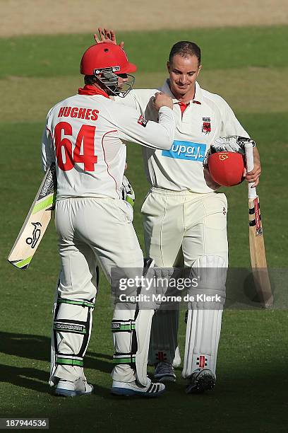 Michael Klinger and Phillip Hughes of the Redbacks leave the field at the end of play on day two of the Sheffield Shield match between the Redbacks...