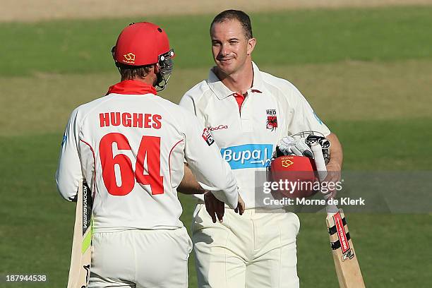 Michael Klinger and Phillip Hughes of the Redbacks leave the field at the end of play on day two of the Sheffield Shield match between the Redbacks...