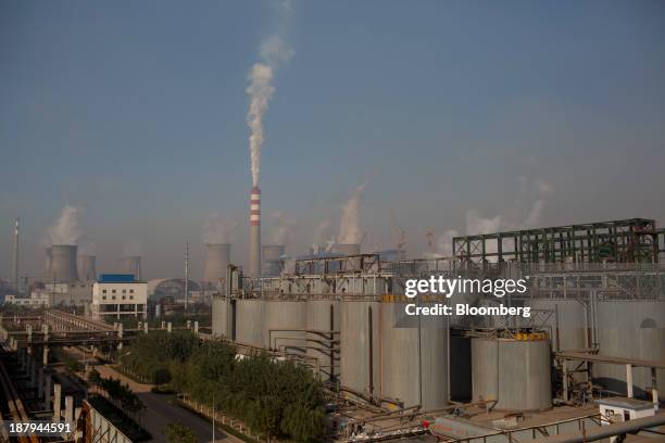 Vapor rises from cooling towers at a power plant, background, at the China Hongqiao Group Ltd. Aluminum smelting facility in Zouping, China, on...