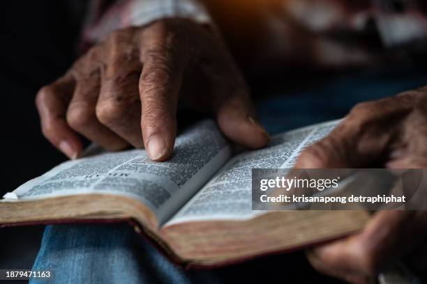 old man reading the holy bible.,bible - holy book stock pictures, royalty-free photos & images