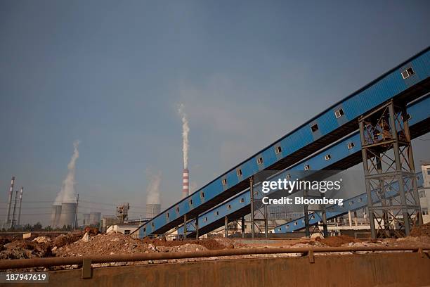 Vapor rises from a power plant, background, at the China Hongqiao Group Ltd. Aluminum smelting facility in Zouping, China, on Monday, Nov. 4, 2013....