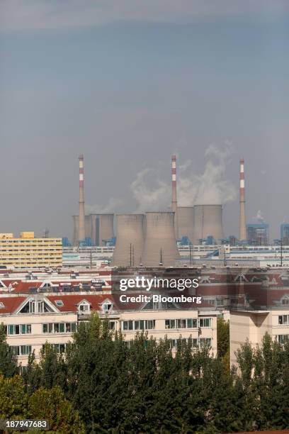 The cooling towers of a power plant emit vapor at the China Hongqiao Group Ltd. Aluminum smelting facility in Zouping, China, on Monday, Nov. 4,...