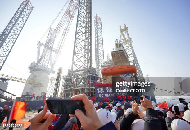 Guests celebrate the delivery of "Bo Qiang 3060" wind power installation ship at CIMC Raffles Yantai construction base in Yantai city, Shandong...