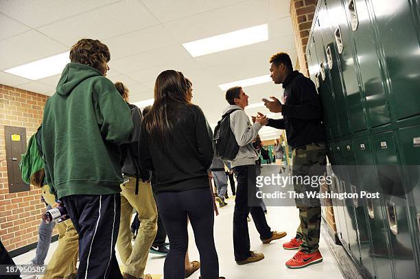 Eric Gum, center, talks with Da'Shawn Hand, right, in the hallway at Woodbridge Senior High School on Wednesday November 13, 2013 in Woodbridge, VA....