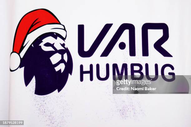 Detailed view of a shirt of a fan of Wolverhampton Wanderers which features the Premier League logo wearing a Christmas Santa Hat, which reads "VAR...