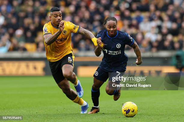 Raheem Sterling of Chelsea is challenged by Mario Lemina of Wolverhampton Wanderers during the Premier League match between Wolverhampton Wanderers...