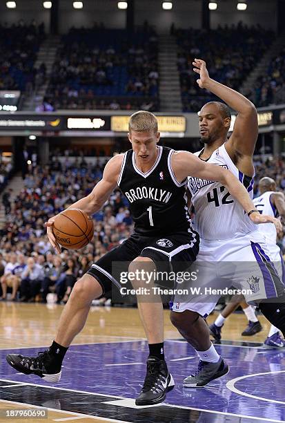 Mason Plumlee of the Brooklyn Nets backs in on Chuck Hayes of the Sacramento Kings at Sleep Train Arena on November 13, 2013 in Sacramento,...