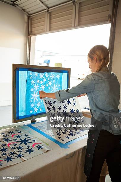 woman silk-screening fabric - glendale california stock pictures, royalty-free photos & images