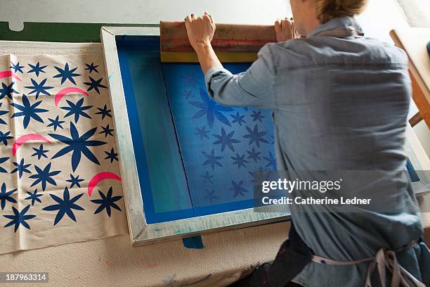 woman silk-screening fabric - silk screen stock pictures, royalty-free photos & images