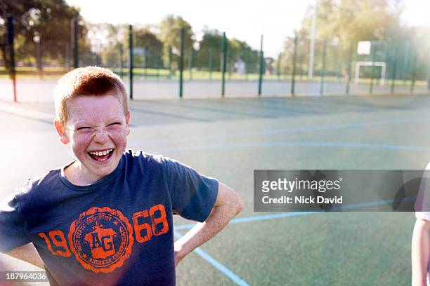 boys playing outside in the park - kid laughing stock-fotos und bilder
