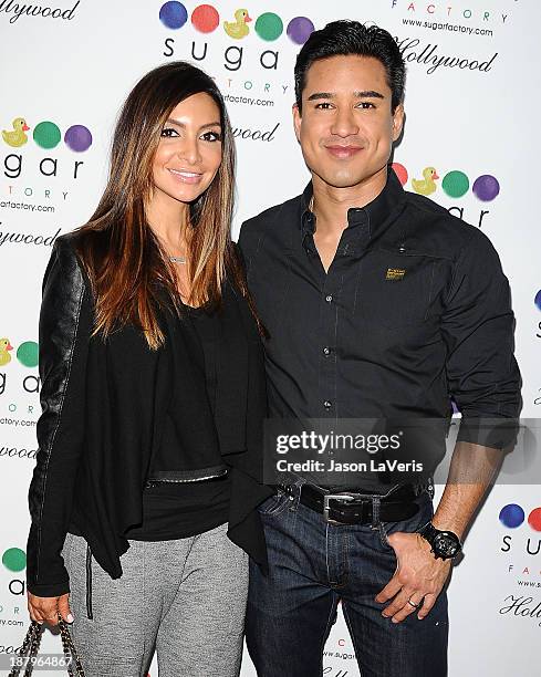 Courtney Mazza and Mario Lopez attend the grand opening of Sugar Factory Hollywood on November 13, 2013 in Hollywood, California.