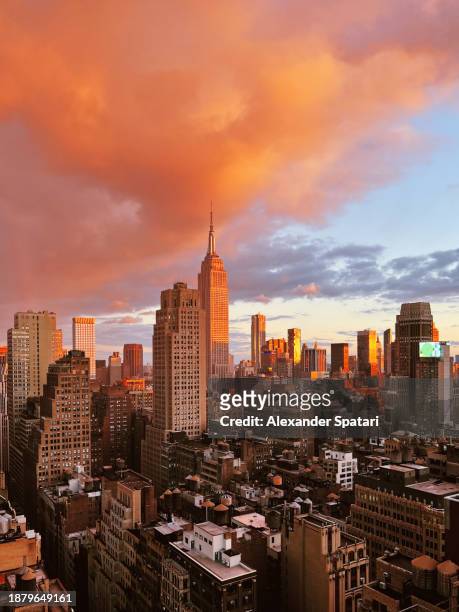 dramatic sunset in manhattan midtown seen from above, new york city, usa - empire state building red stock pictures, royalty-free photos & images