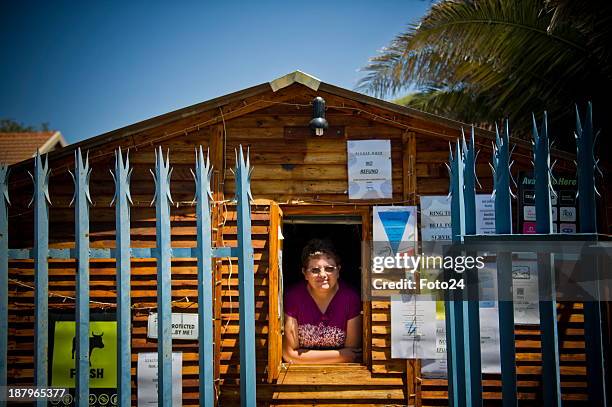 Florence van Niekerk at her spaza shop on November 12, 2013 in Kempton Park, South Africa. She sells airtime, bread, sweets and cigarettes and also...