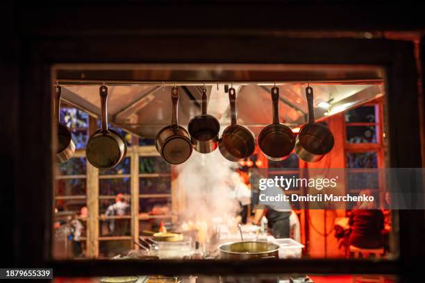 cooking in modern restaurant with open kitchen. red lighting in interior of designer cafe. - cozinha industrial imagens e fotografias de stock