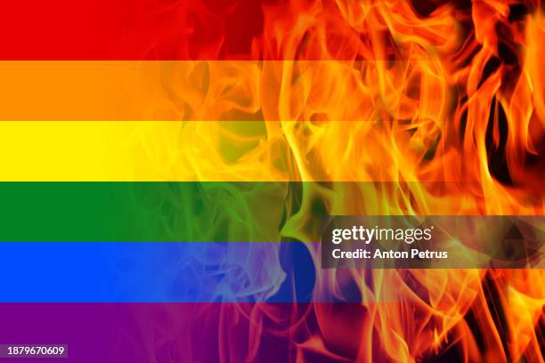 lgbt flag on a background of flames - riot fire stock pictures, royalty-free photos & images