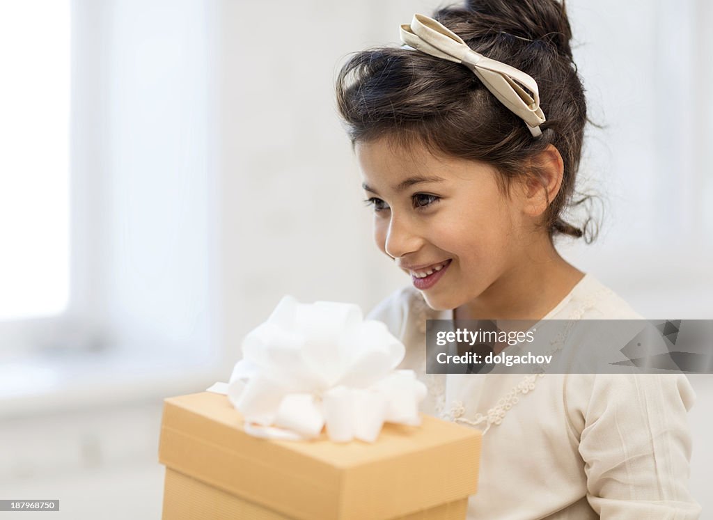 Happy child girl with gift box