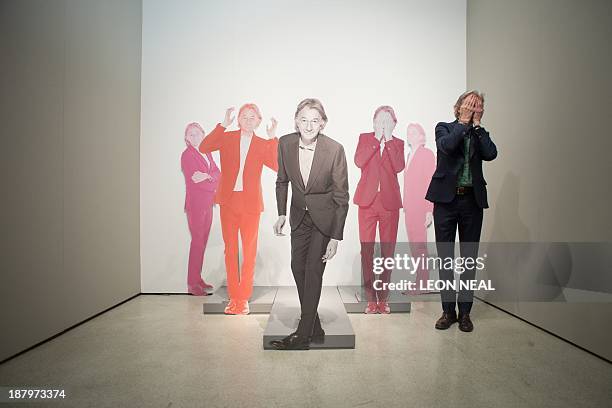 British designer Paul Smith poses with cardboard cut-outs of himself at the opening of the "Hello, My Name is Paul Smith" exhibition at Design Museum...