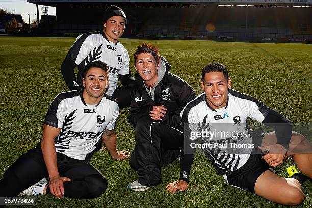 Staff member Carmen Taplin of New Zealand poses for a photograph with Shaun Johnson , Kevin Locke and Roger Tuivasa-Sheck during the New Zealand...