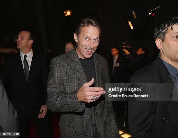 Team photographer for the Detroit Red Wings, Dave Reginek walks the red carpet prior to the 2013 Hockey Hall of Fame induction ceremony on November...