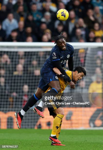 Hwang Hee-Chan of Wolverhampton Wanderers contends for the aerial ball with Axel Disasi of Chelsea during the Premier League match between...
