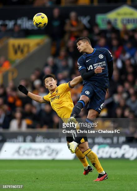 Thiago Silva of Chelsea contends for the aerial ball whilst under pressure from Hwang Hee-Chan of Wolverhampton Wanderers during the Premier League...