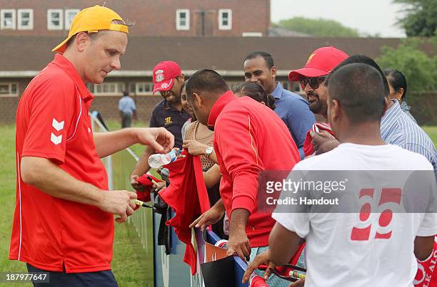 Dietmar Hamann signs autographs during the Liverpool FC Legends Tour, CSI and Coaching Clinic at Siphosethu Primary School on November 14, 2013 in...