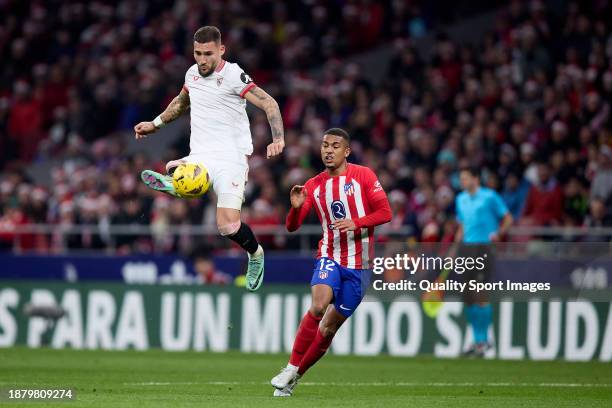 Nemanja Gudelj of Sevilla FC competes for the ball with Samuel Lino of Atletico de Madrid during the LaLiga EA Sports match between Atletico Madrid...