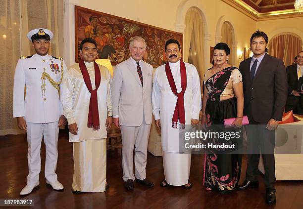 In this handout photo provided by Sri Lankan Government, Prince Charles, Prince of Wales poses with Sri Lankan President Mahinda Rajapaksa and his...