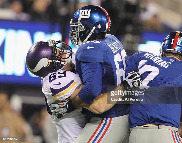 Defensive End Jared Allen of the Minnesota Vikings reaches around Tackle Will Beatty to one-arm Sack Quarterback Eli Manning of the New York Giants...