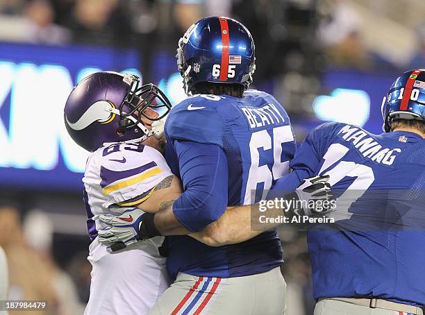 Defensive End Jared Allen of the Minnesota Vikings reaches around Tackle Will Beatty to one-arm Sack Quarterback Eli Manning of the New York Giants...