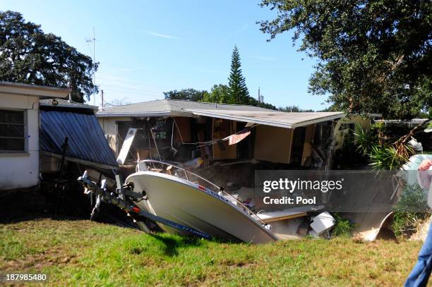 The rear portion of a residential home is consumed by a sinkhole November 14, 2013 in Dunedin, Florida. According to reports, the large sinkhole...