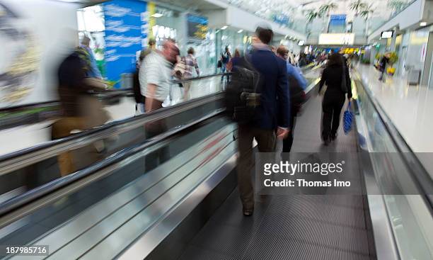 People rushing trough the airport of Bangkok, people on a moving walkway.