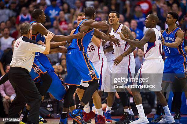 Los Angeles Clippers Matt Barnes and Oklahoma City Thunder Serge Ibaka skirmish in the final seconds of the second quarter, during NBA action,...