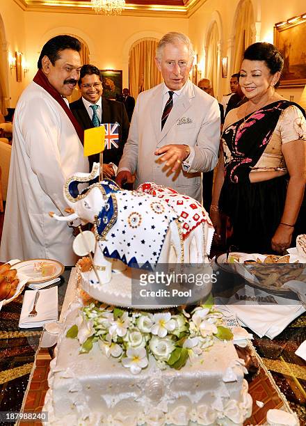 Prince Charles, Prince of Wales is presented with a birthday cake topped with three Elephants, by the President of Sri Lanka Mahinda Rajapaksa and...