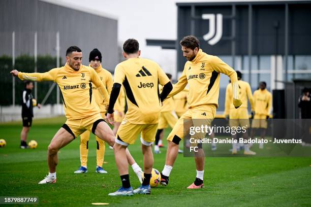 Filip Kostic, Manuel Locatelli of Juventus during a training session at JTC on December 27, 2023 in Turin, Italy.