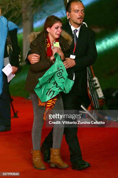 Fan is escorted by security at the 'The Hunger Games: Catching Fire' Premiere during The 8th Rome Film Festival at Auditorium Parco Della Musica on...